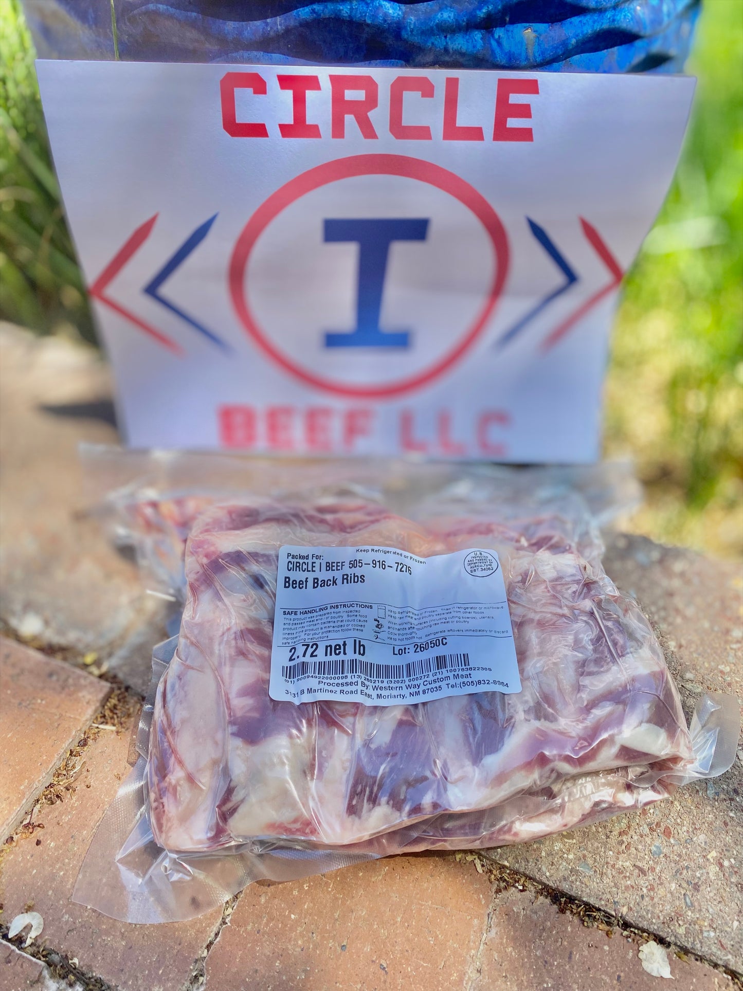Packaged beef ribs with a 'Circle I Beef LLC' label on a stone surface.