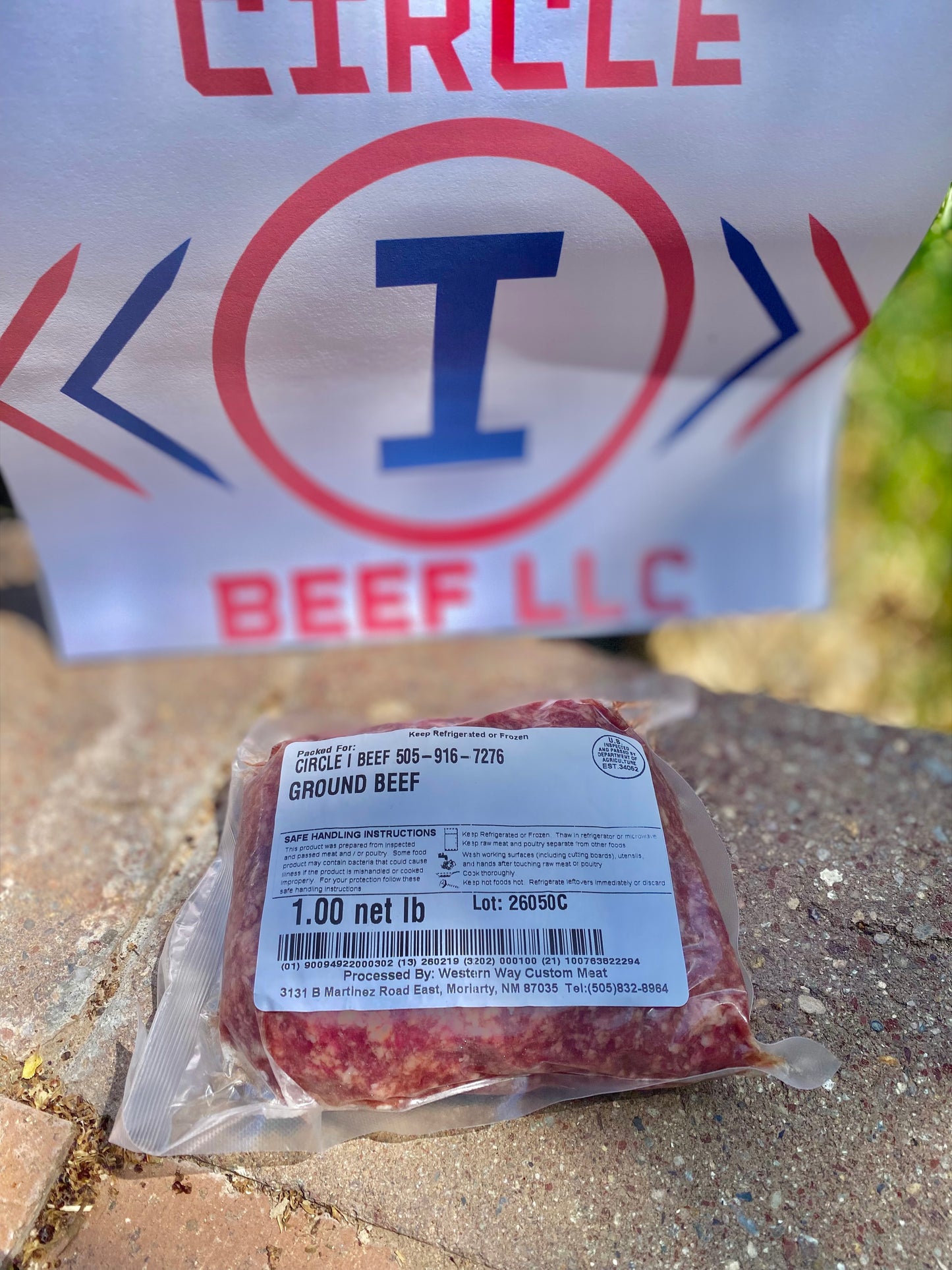 Packaged ground beef with Circle I Beef LLC logo in the background