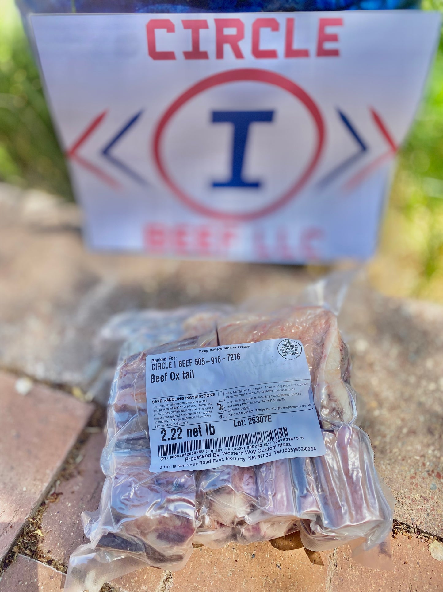 Packaged beef on a concrete surface with 'Circle I Beef LLC' logo in the background.