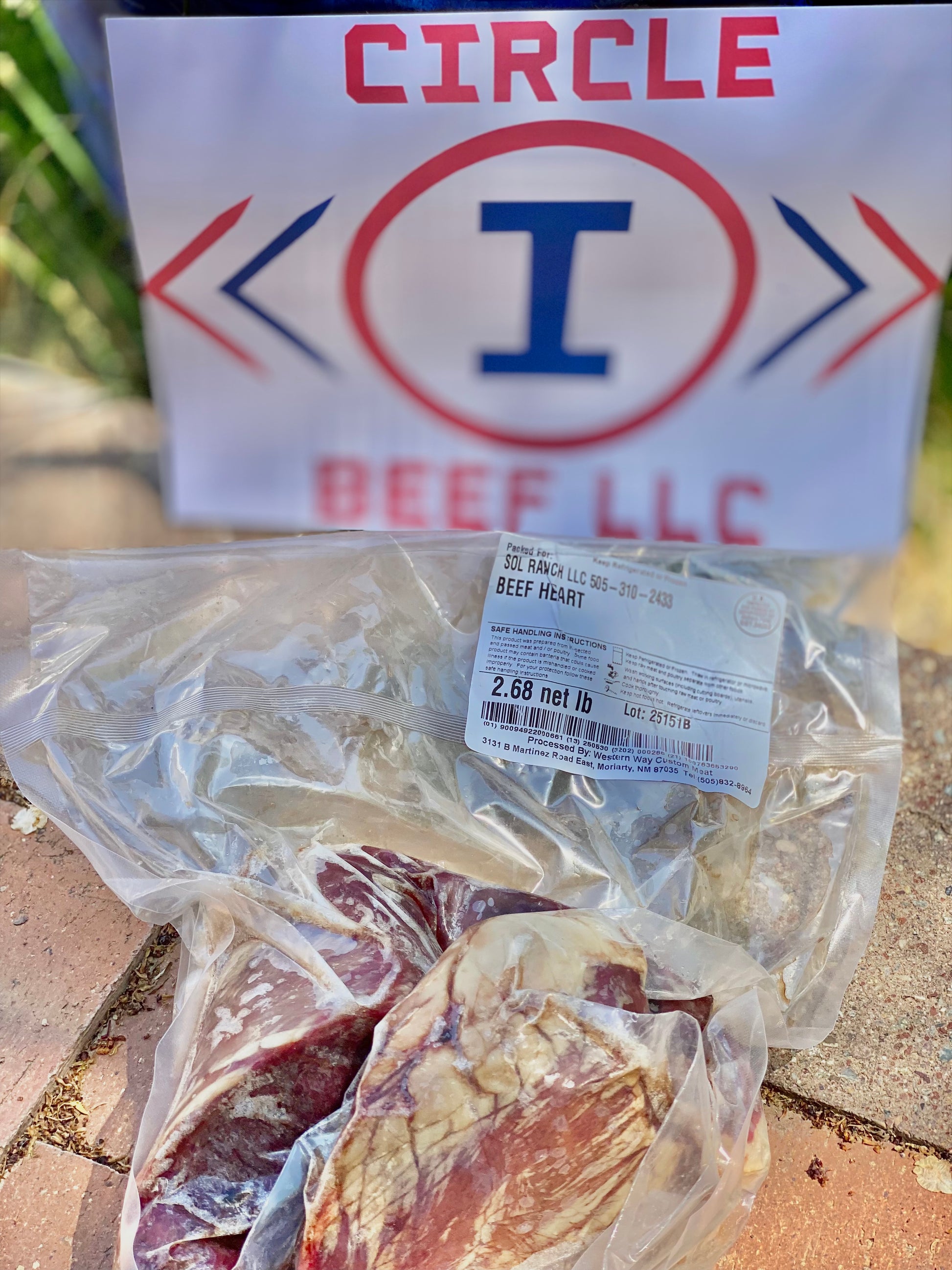 Packaged beef heart with Circle I Beef LLC logo in the background