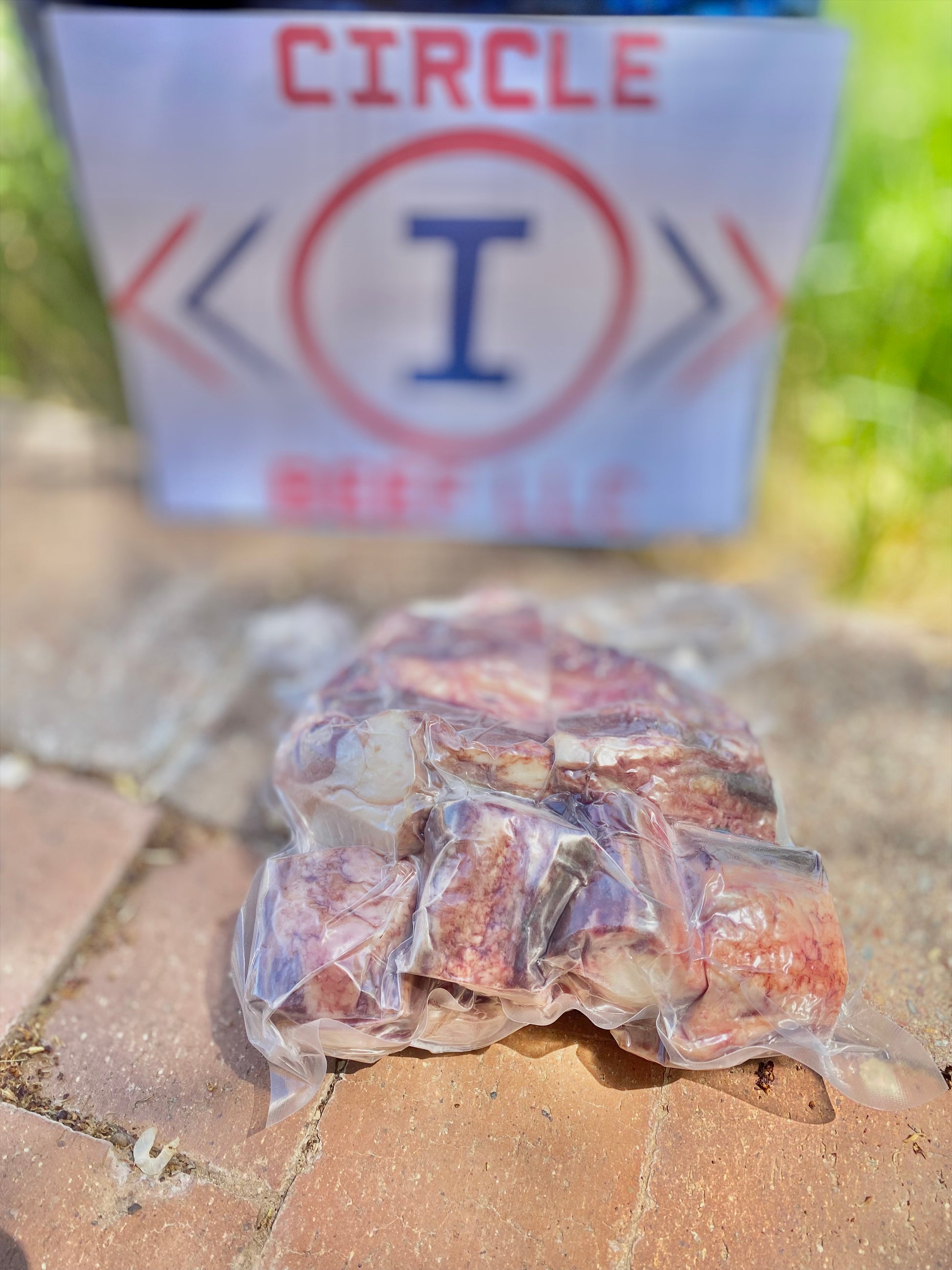 Packaged meat product on a concrete surface with 'Circle I' branding in the background.